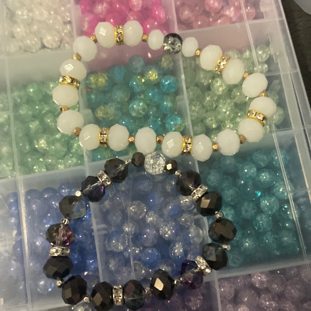 2 bracelets one thats gray and one with white beads💋